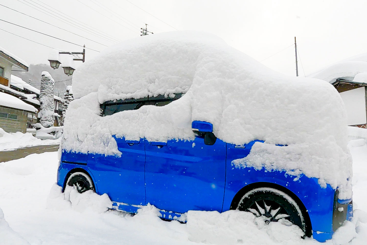 blue car covered in snow